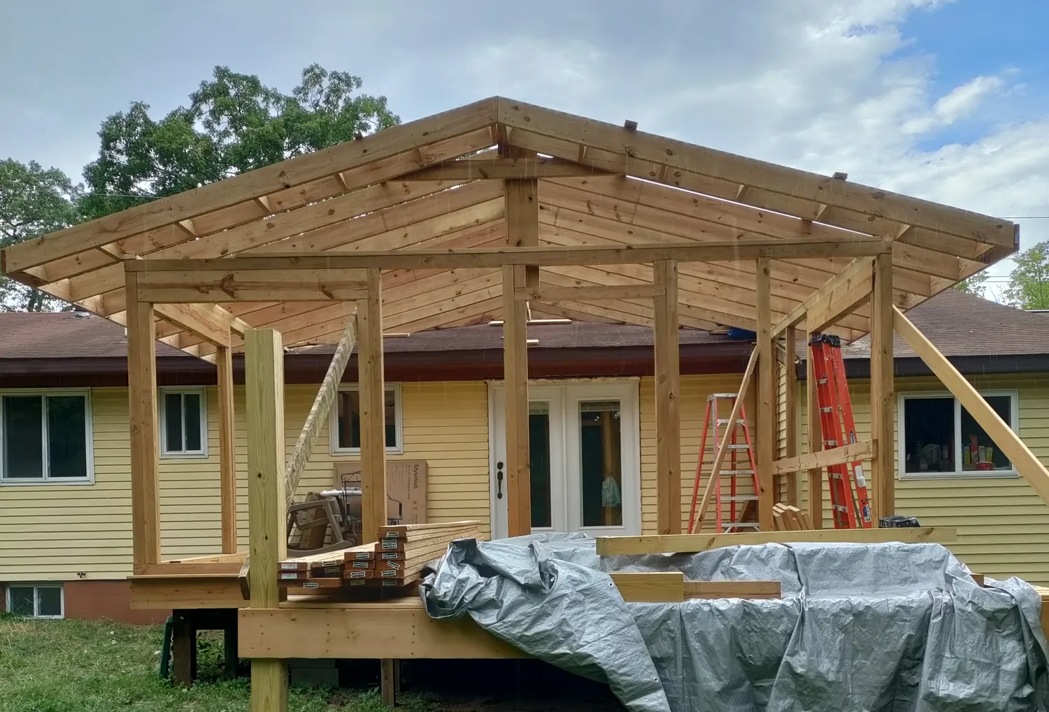 Gable porch roof framed and sheathed over a new deck